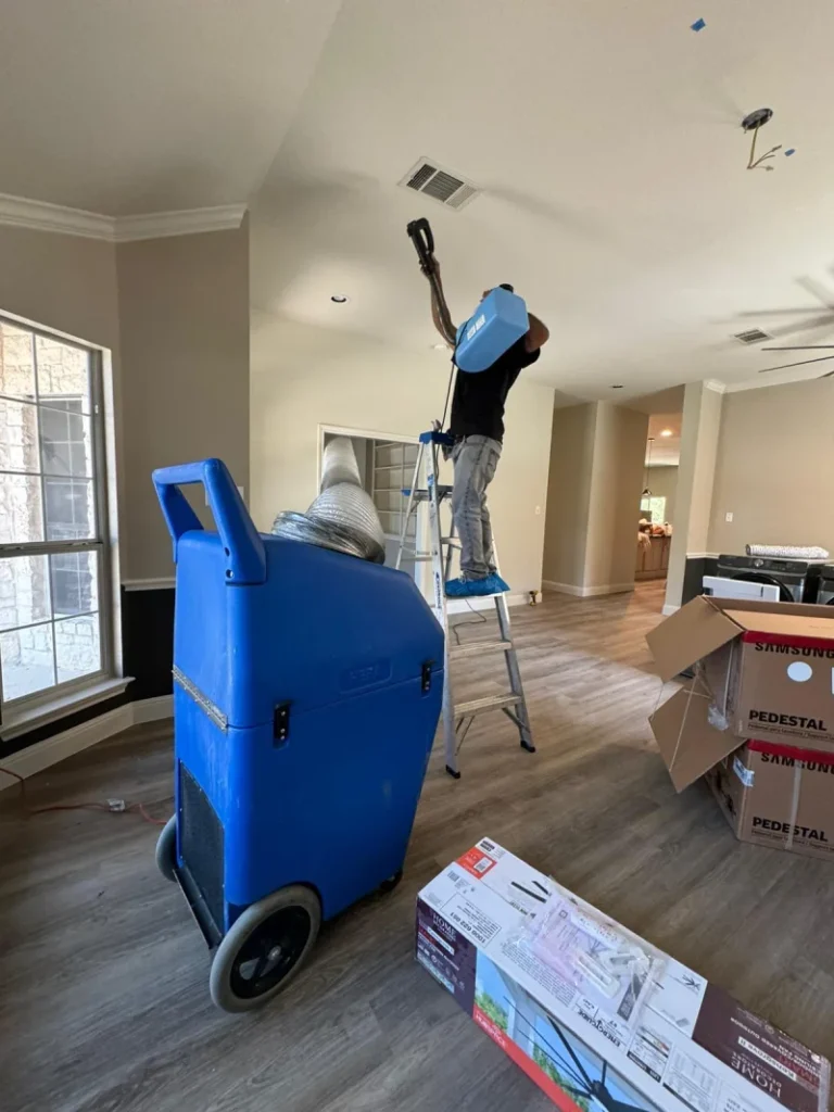 Supreme Air Care technician cleaning a residential air duct using a negative air machine.