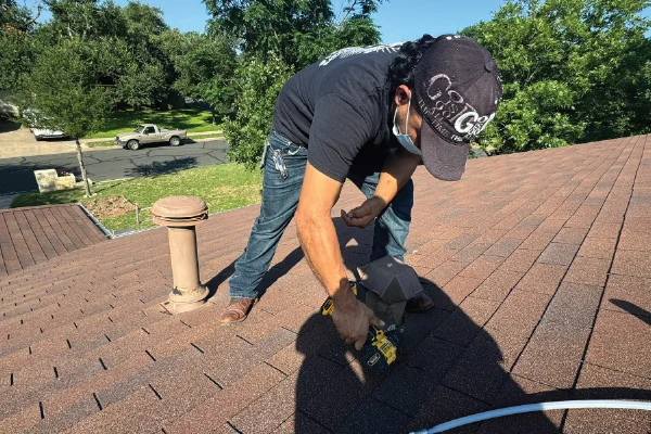 Supreme Air Care technician cleaning a clogged dryer vent in Austin, TX