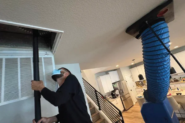 HVAC technician cleaning air ducts in an Austin home