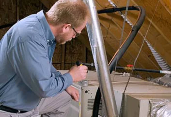 Supreme air care professional doing HVAC system inspection and cleaning in a residential home.