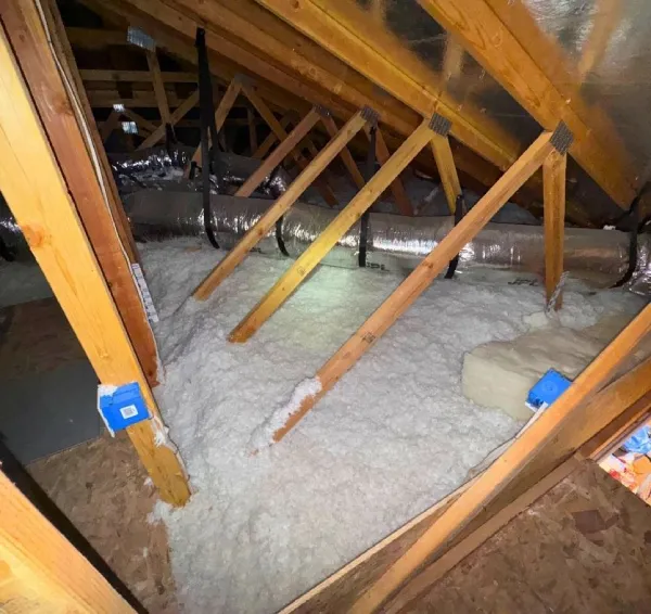 Professional attic insulation installation in a residential home.
